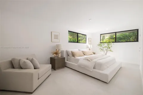 a living room with furniture and painting on the wall