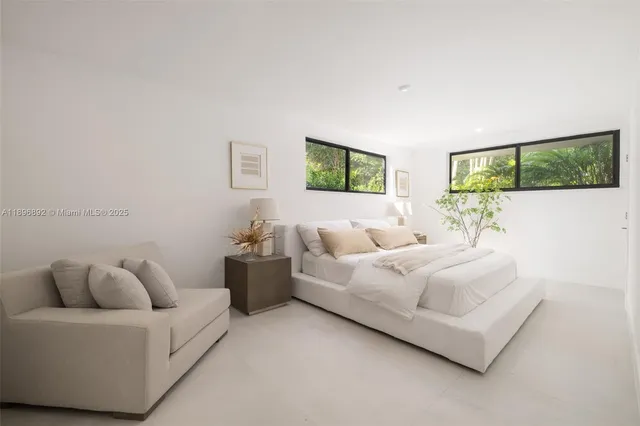 a living room with furniture and painting on the wall