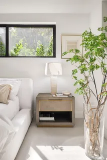 a living room with a couch and a potted plant