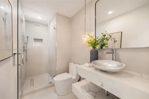 a bathroom with a toilet a sink and shower