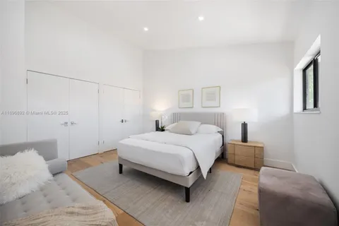 a bedroom with a bed and a night stand