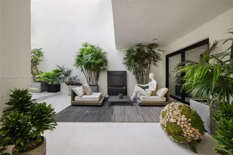 a living room with furniture potted plant and a fireplace