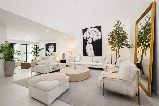 a living room with furniture and a large mirror