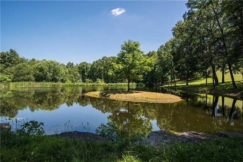 399 Cornetti Road Fenelton, PA 16034 - Photo 23 of 25 a view of a lake with a yard and outdoor seating
