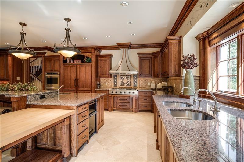 399 Cornetti Road Fenelton, PA 16034 - Photo 8 of 25 a kitchen with stainless steel appliances granite countertop a sink a stove and a wooden floors