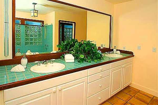 7463 B Koolau Road Kilauea, HI 96754 - Photo 12 of 21 a bathroom with a granite countertop sink and a large mirror
