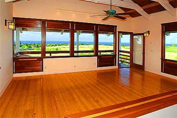 7463 B Koolau Road Kilauea, HI 96754 - Photo 6 of 21 a view of an empty room with wooden floor and a window