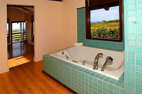 7463 B Koolau Road Kilauea, HI 96754 - Photo 8 of 21 a bathroom with a bathtub and shower