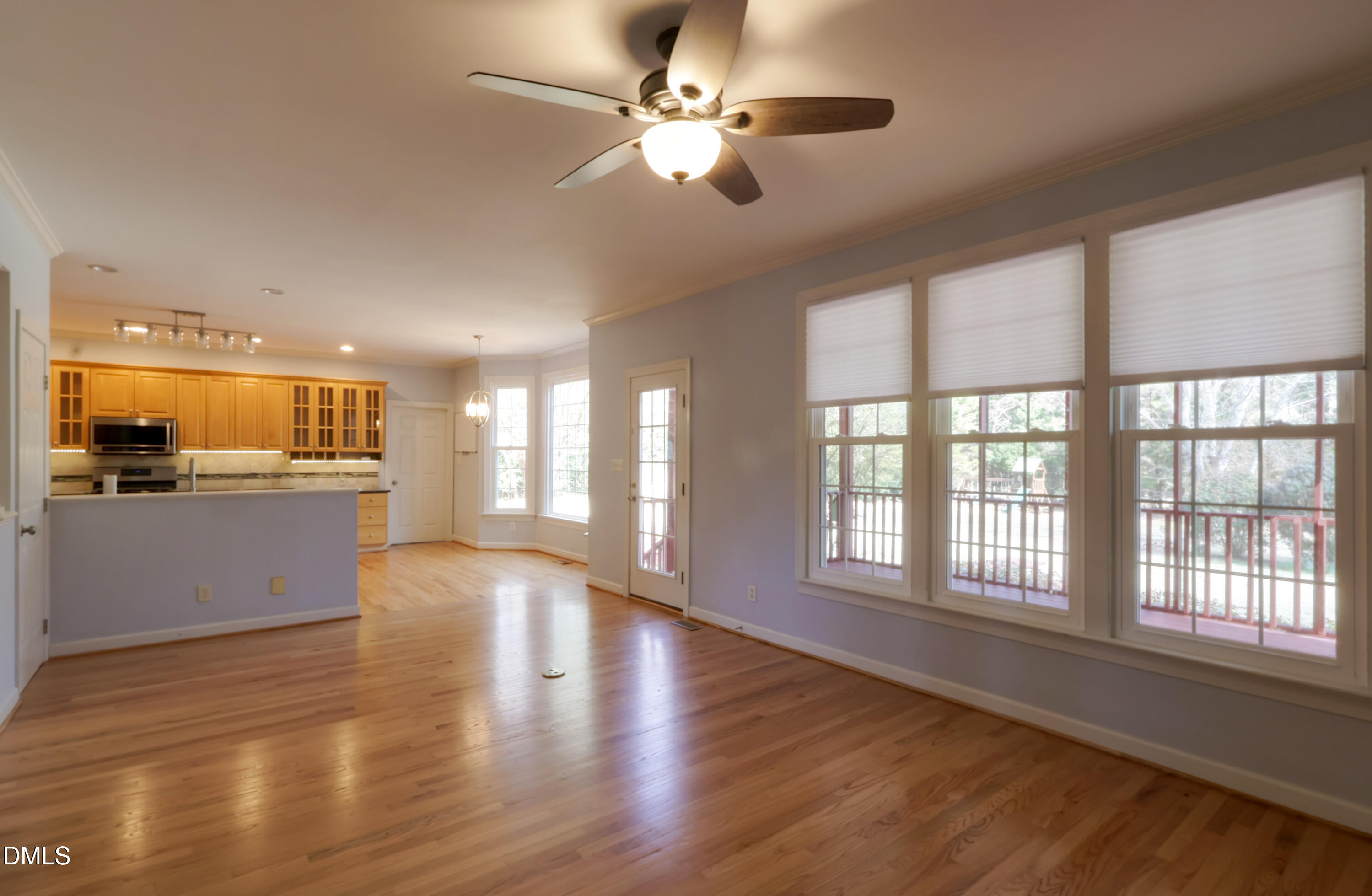 2504 Pennyshire Lane Raleigh, NC 27606 - Photo 13 of 32 a view of an empty room with window and wooden floor