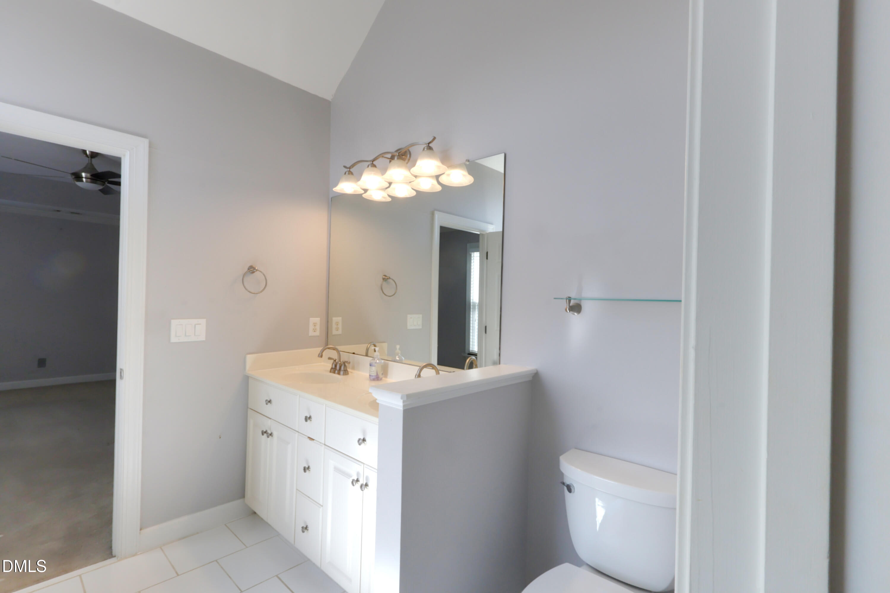 2504 Pennyshire Lane Raleigh, NC 27606 - Photo 17 of 32 a bathroom with a toilet sink and mirror