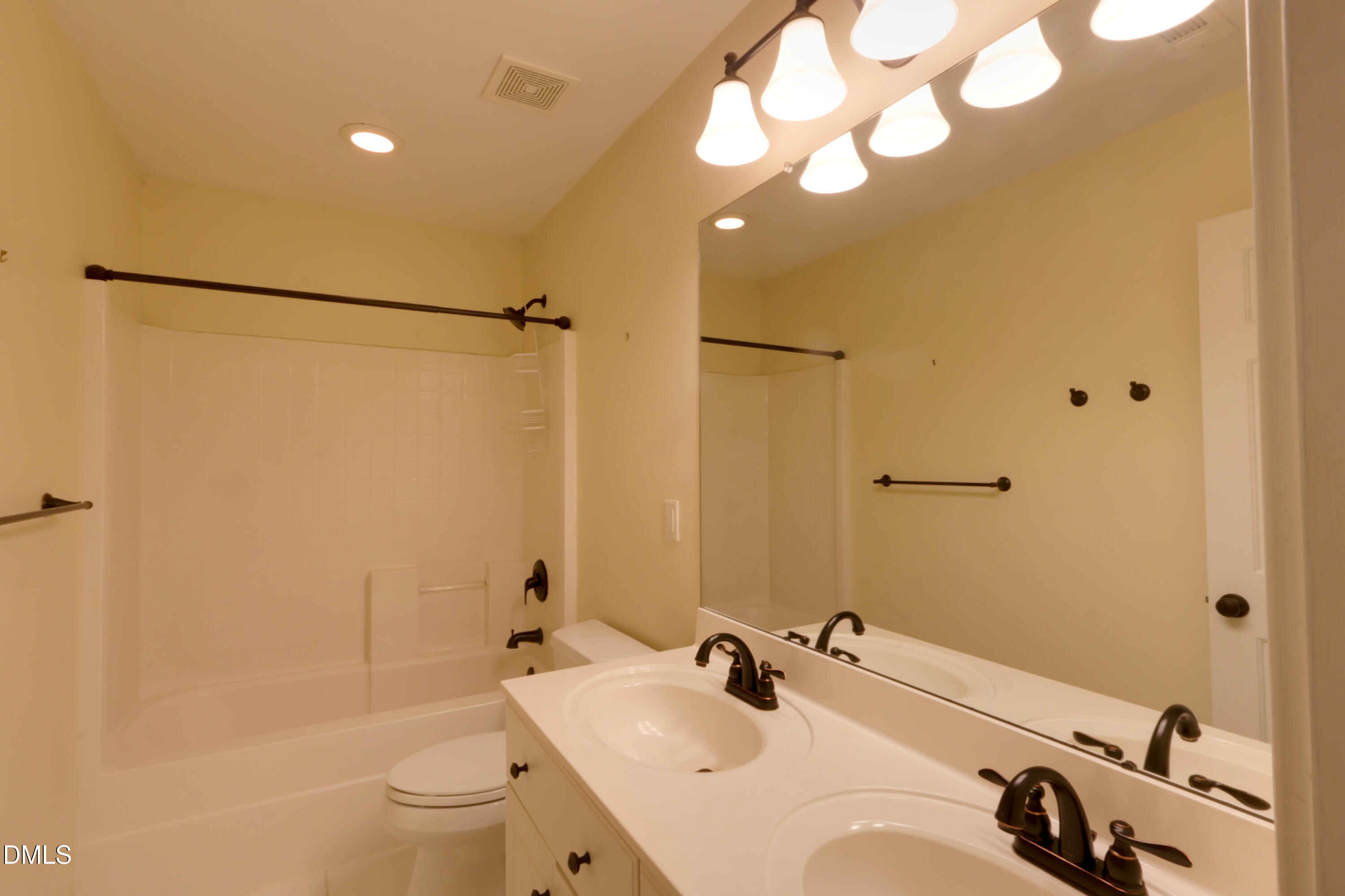 2504 Pennyshire Lane Raleigh, NC 27606 - Photo 21 of 32 a bathroom with a sink and a mirror