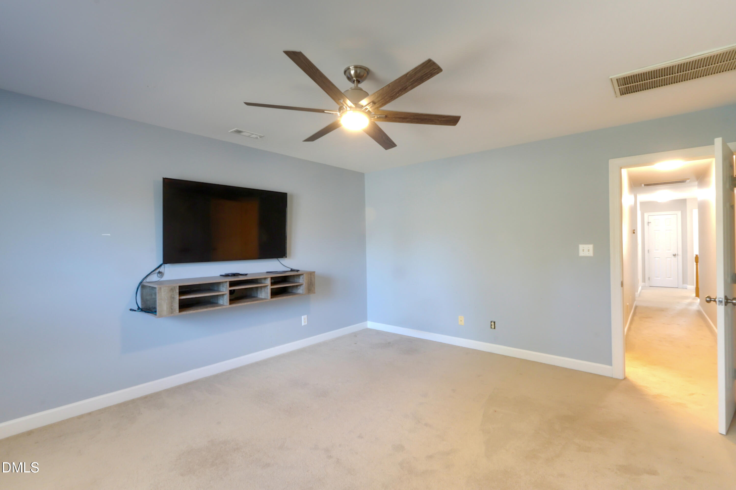 2504 Pennyshire Lane Raleigh, NC 27606 - Photo 22 of 32 a view of room with flat screen tv and ceiling fan