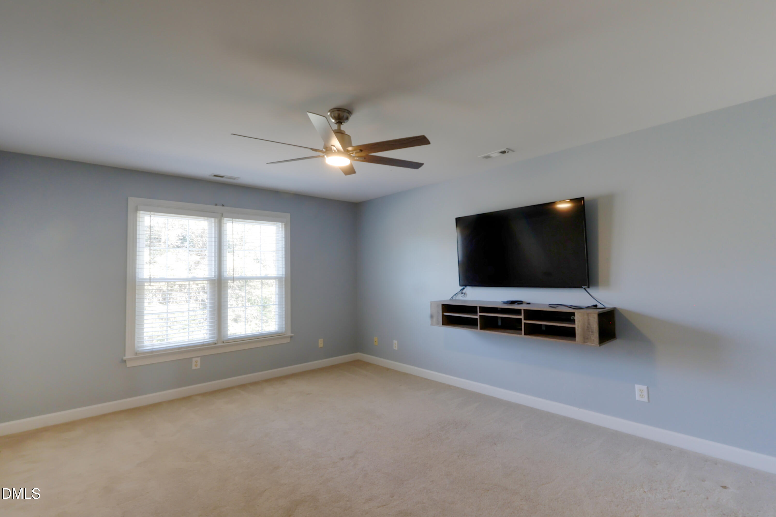2504 Pennyshire Lane Raleigh, NC 27606 - Photo 23 of 32 an empty room with windows fan and a window