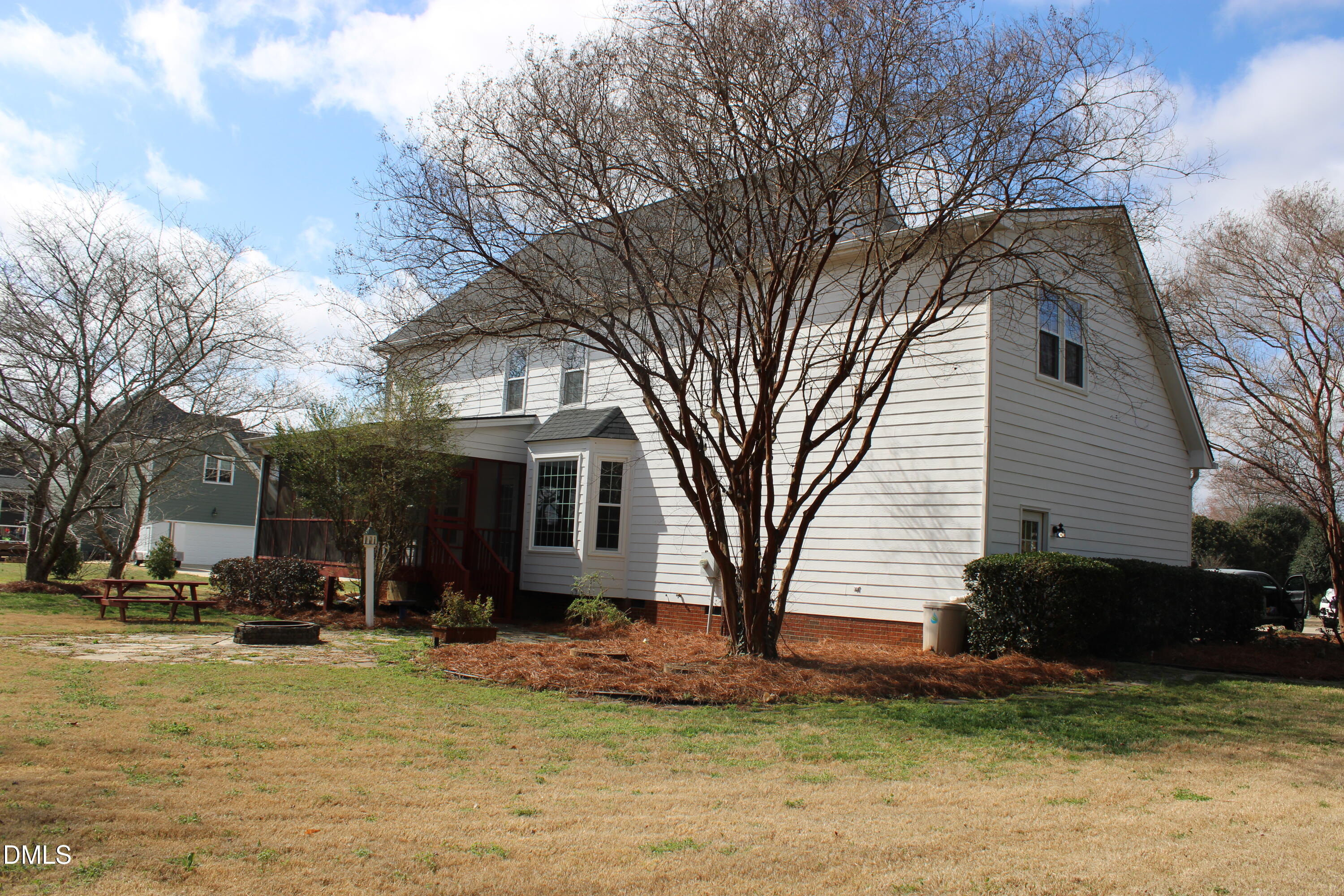 2504 Pennyshire Lane Raleigh, NC 27606 - Photo 26 of 32 a view of a white house with a yard covered with snow