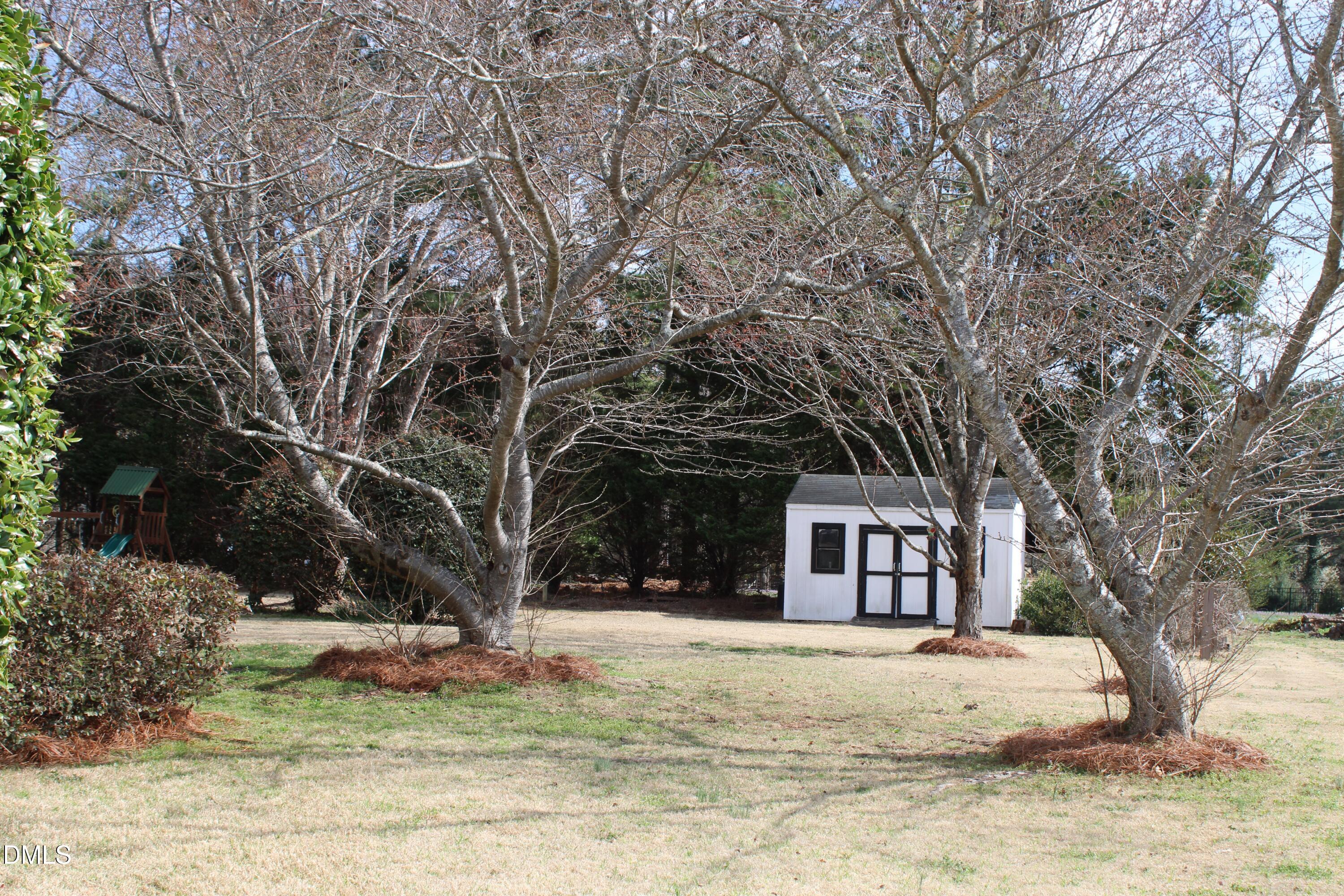 2504 Pennyshire Lane Raleigh, NC 27606 - Photo 31 of 32 a view of a house with trees in the background
