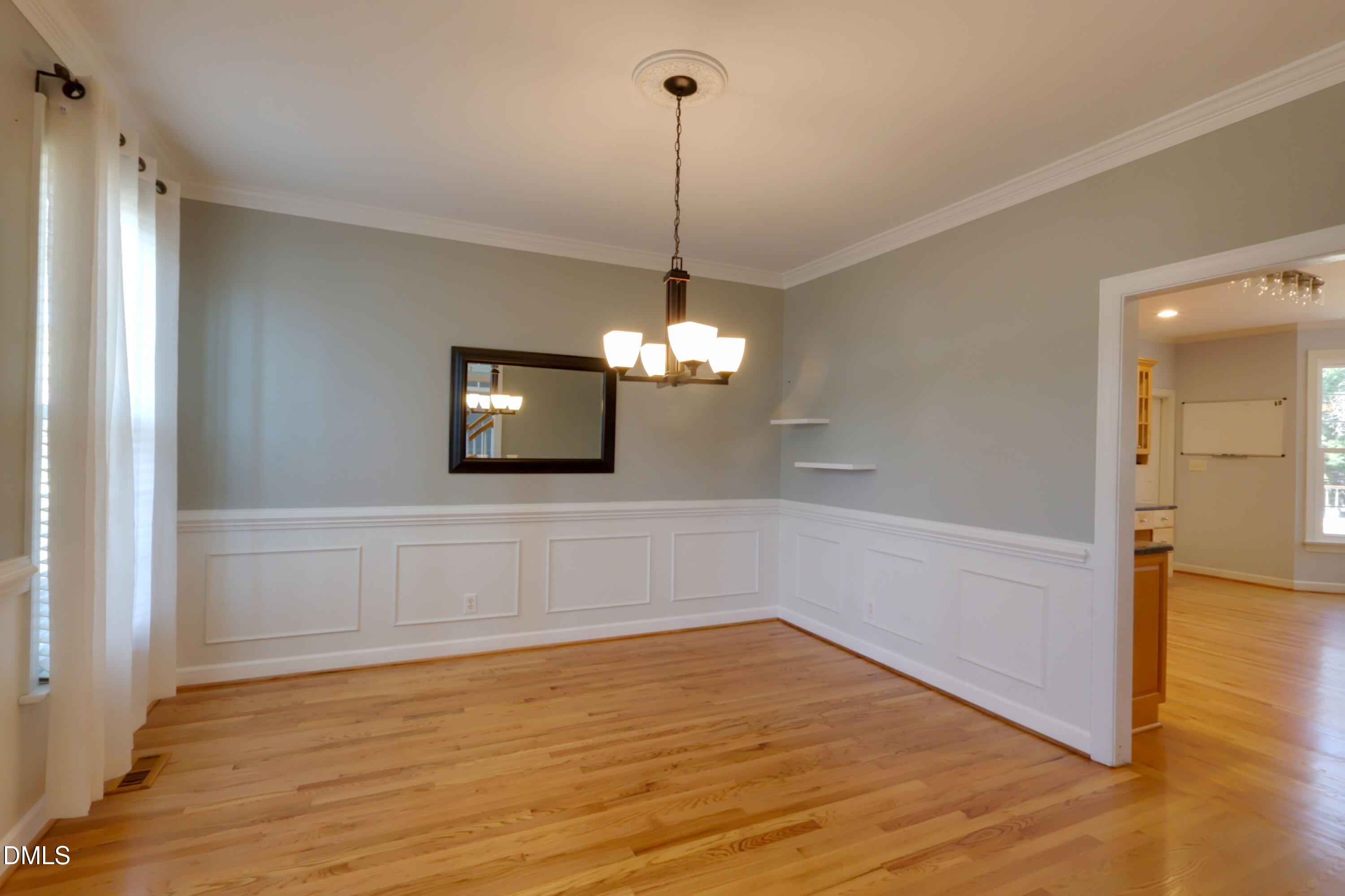 2504 Pennyshire Lane Raleigh, NC 27606 - Photo 7 of 32 a view of a room with wooden floor chandelier and entryway