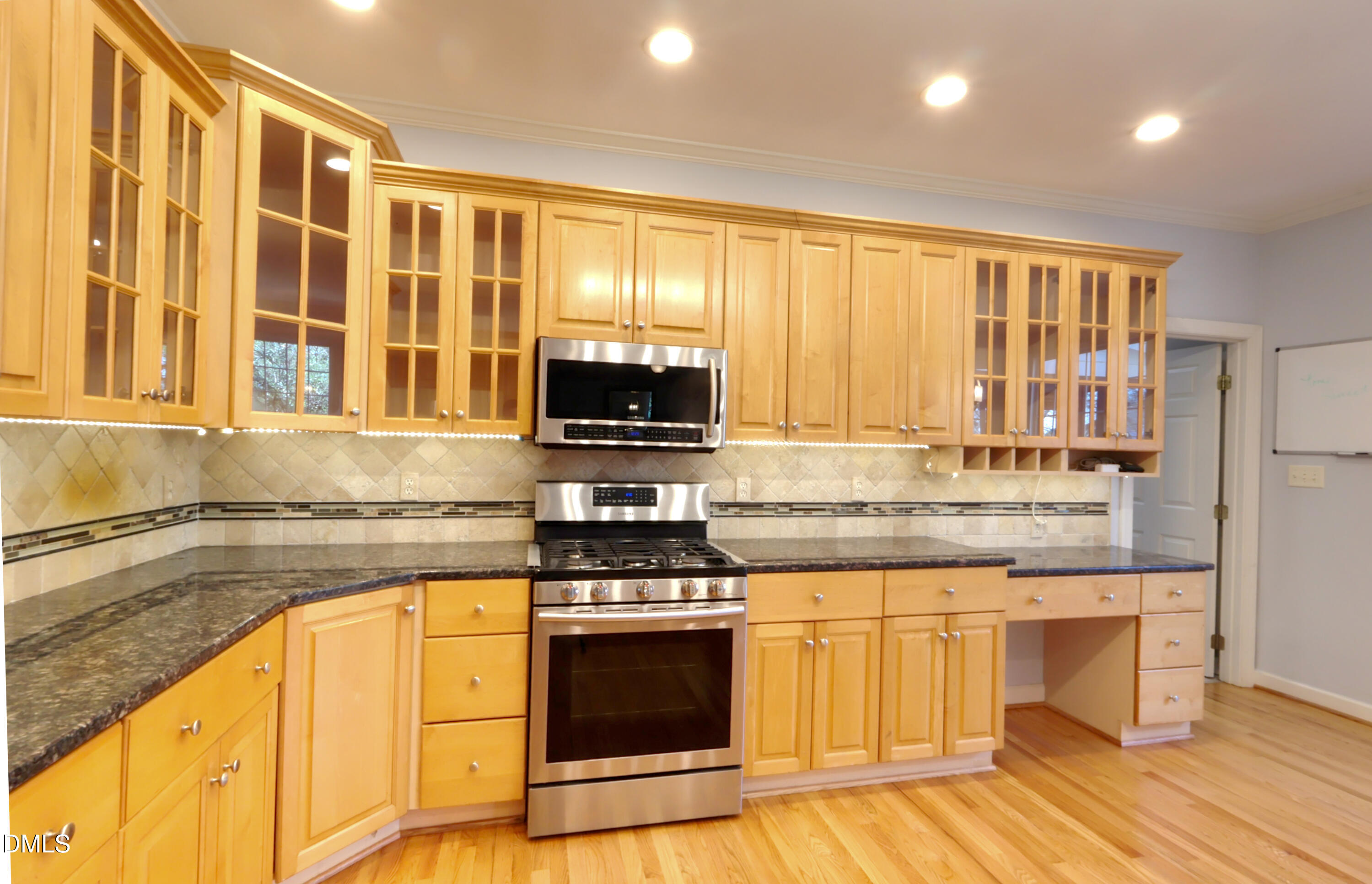 2504 Pennyshire Lane Raleigh, NC 27606 - Photo 9 of 32 a kitchen with stainless steel appliances granite countertop a stove and a sink