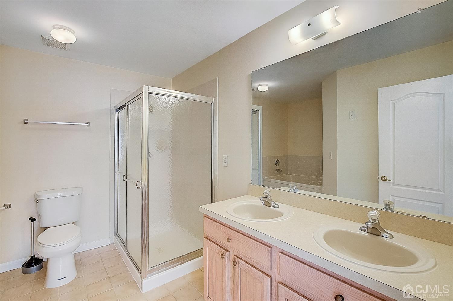 38 Hawthorne Road North Brunswick, NJ 08902 - Photo 14 of 26 a bathroom with a toilet a sink a mirror and a shower