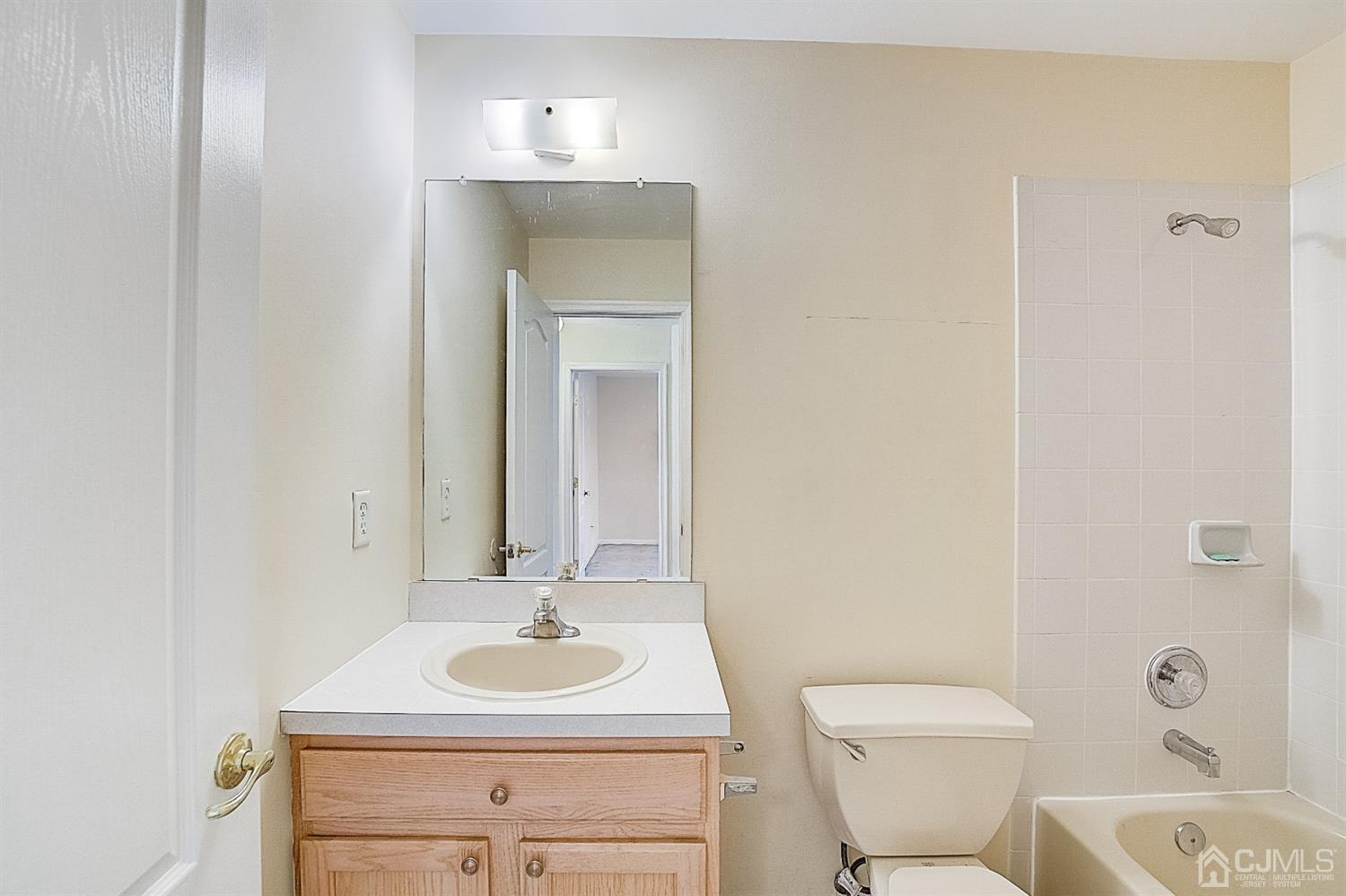 38 Hawthorne Road North Brunswick, NJ 08902 - Photo 19 of 26 a bathroom with a sink toilet and a mirror