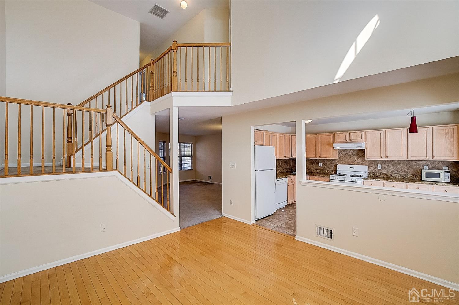 38 Hawthorne Road North Brunswick, NJ 08902 - Photo 3 of 26 a view of a kitchen with kitchen island wooden floor and a living room