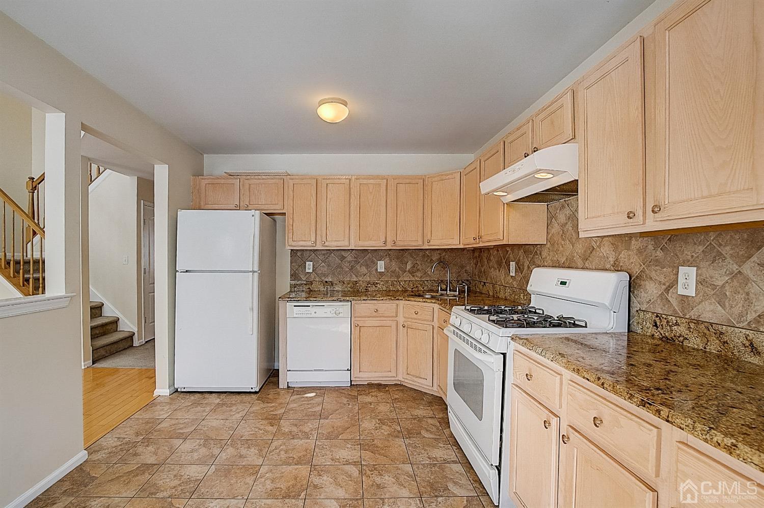 38 Hawthorne Road North Brunswick, NJ 08902 - Photo 7 of 26 a kitchen with a refrigerator sink stove and cabinets