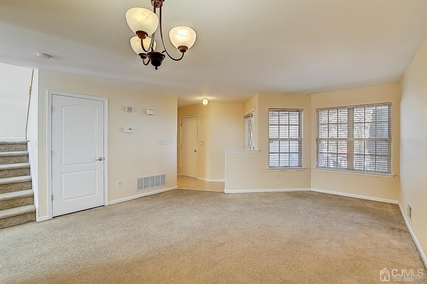38 Hawthorne Road North Brunswick, NJ 08902 - Photo 10 of 26 an empty room with wooden floor and windows