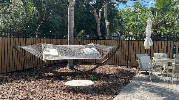 a view of a patio with a table and chairs