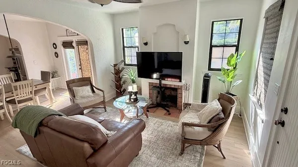 a living room with furniture a flat screen tv and a fireplace