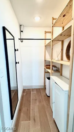 a view of walk in closet with empty racks