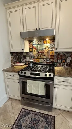 a stove top oven sitting inside of a kitchen