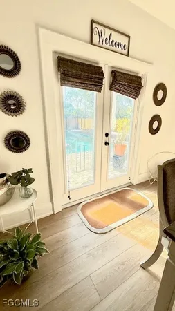 a view of a livingroom with wooden floor and a sink
