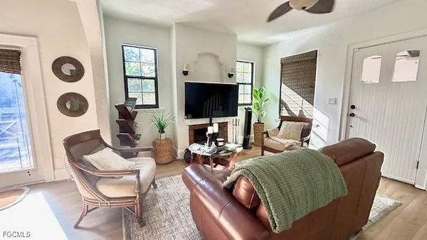 a living room with furniture a flat screen tv and a window