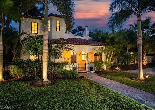 a front view of house with a garden