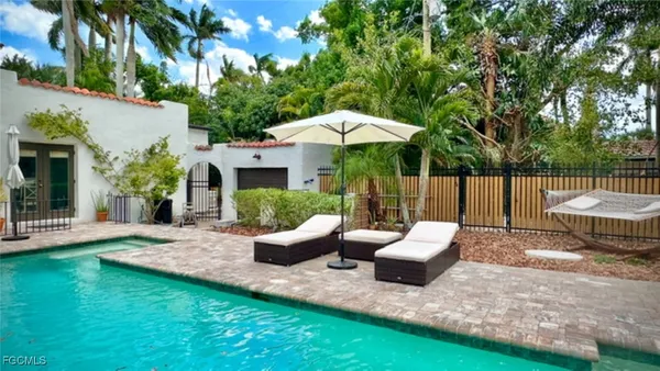 a view of a patio with couches table and chairs and potted plants