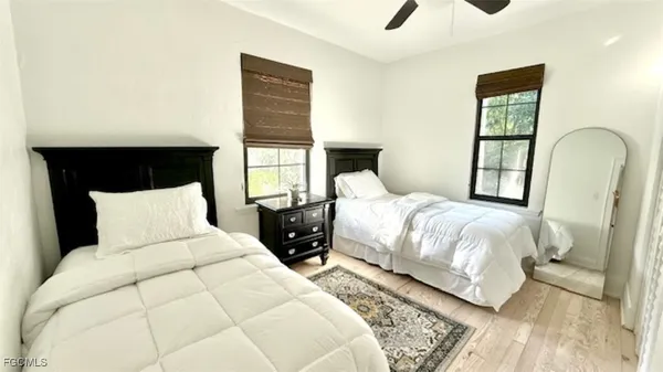 a bedroom with a bed and wooden floor