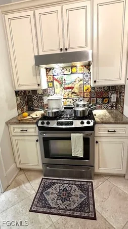 a view of a stove top oven and cabinets
