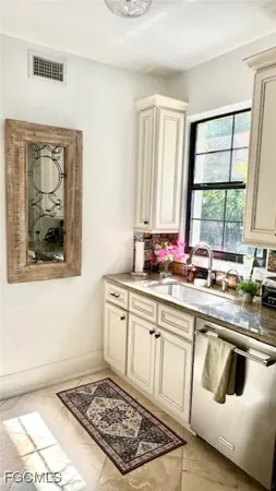 a kitchen with white cabinets and white appliances