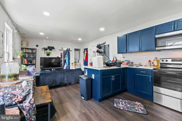 a kitchen with stainless steel appliances granite countertop a sink stove and microwave