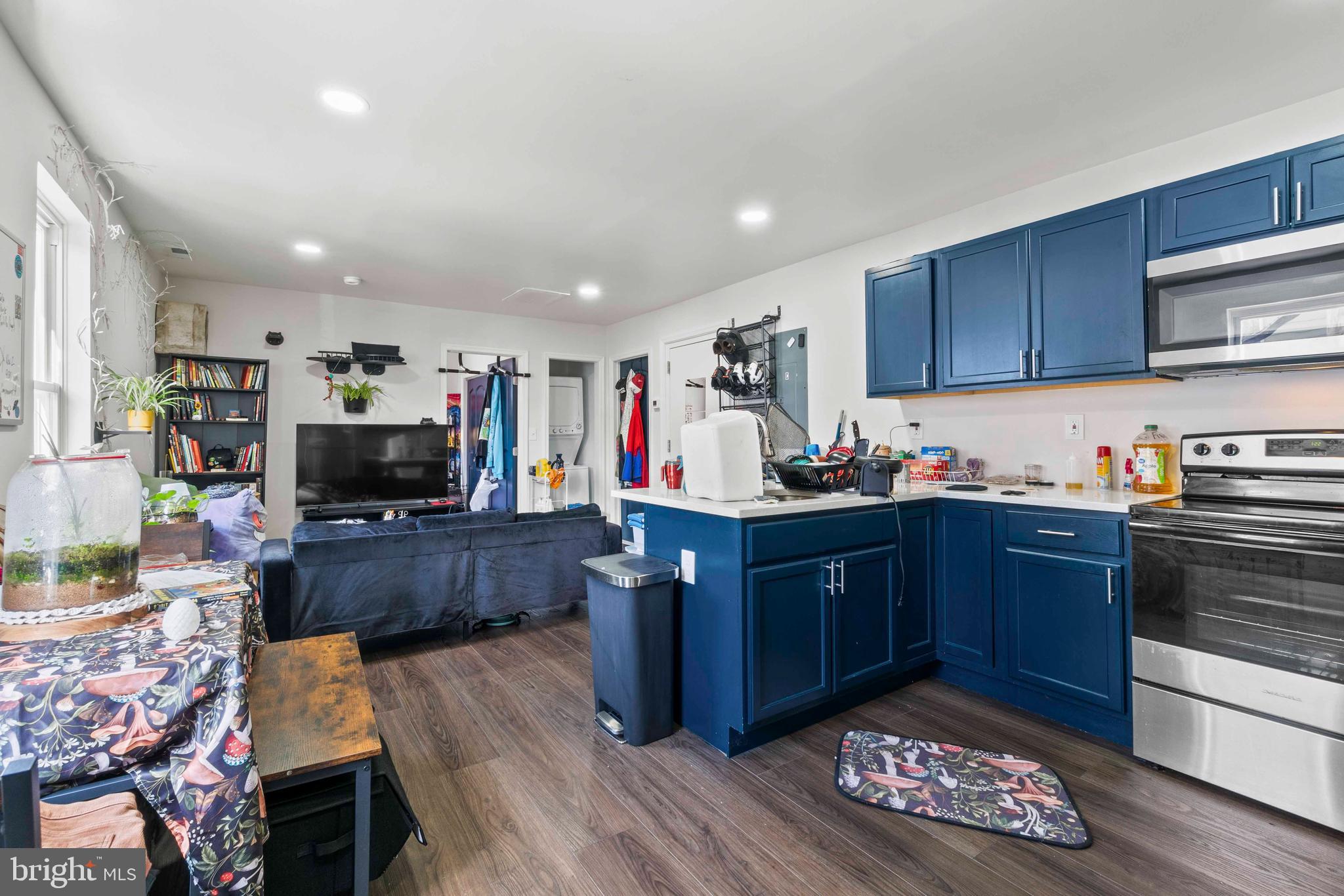 1602 Cypress Street Curtis Bay, MD 21226 - Photo 11 of 42 a kitchen with stainless steel appliances kitchen island granite countertop a stove refrigerator and cabinets