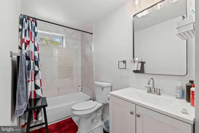 a living room with furniture a rug and a window