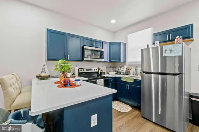 a kitchen with a sink a stove and refrigerator