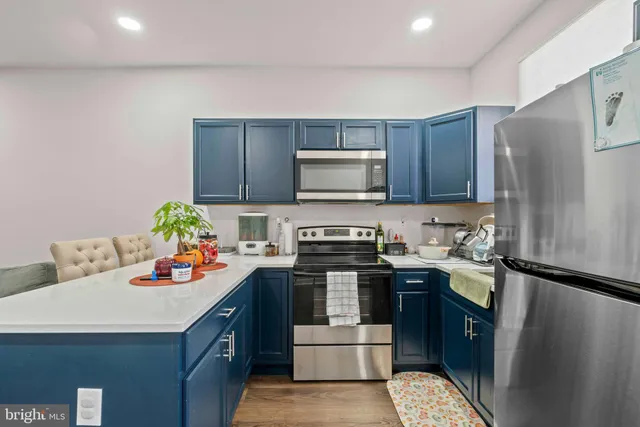 a kitchen with a stove and a wooden cabinets