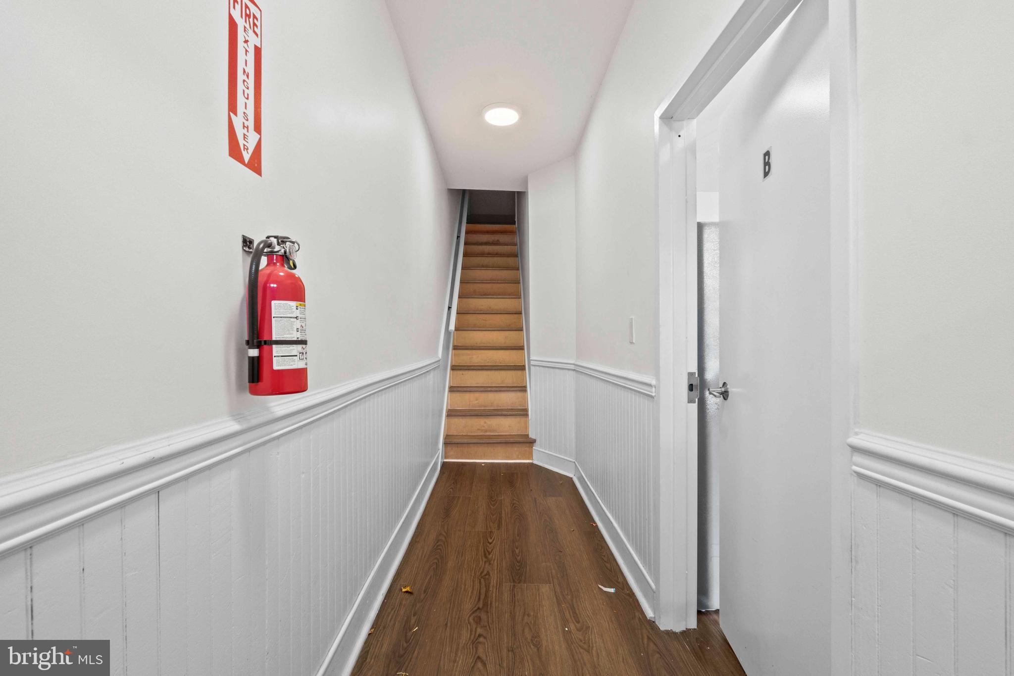 1602 Cypress Street Curtis Bay, MD 21226 - Photo 4 of 42 a view of a hallway with wooden floor and staircase
