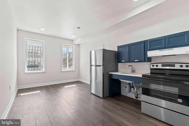a kitchen with stainless steel appliances a refrigerator and a stove top oven