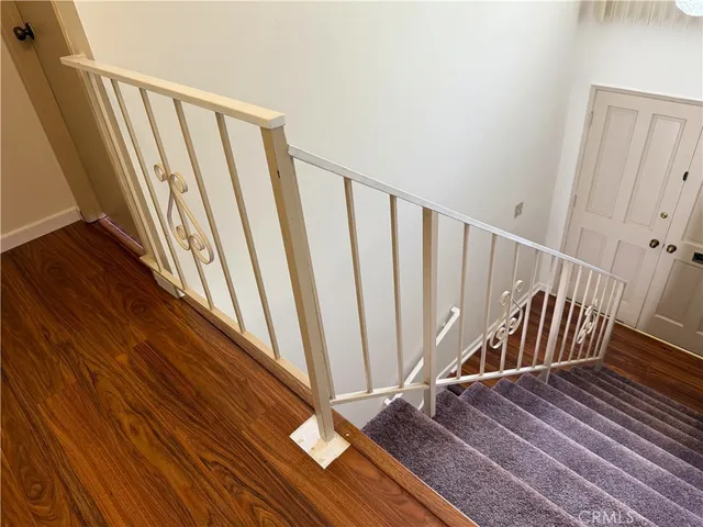 a view of wooden floor with staircase