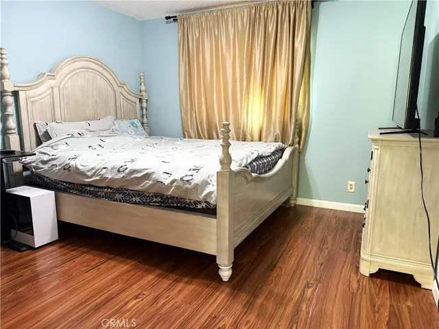 a bed sitting in a bedroom next to a window