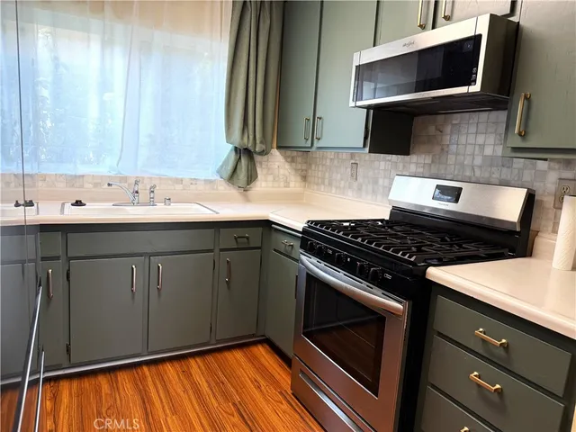 a kitchen with a sink stove and microwave