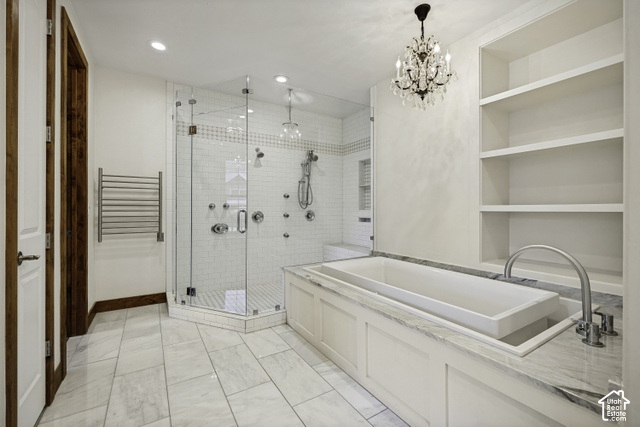 259 Twin River Loop Alpine, UT 84004 - Photo 19 of 61 Luxurious built-in soaker tub with chandelier overhead, shelving for towels, candles, etc. Expansive frameless glass-enclosed shower with multiple showerheads.