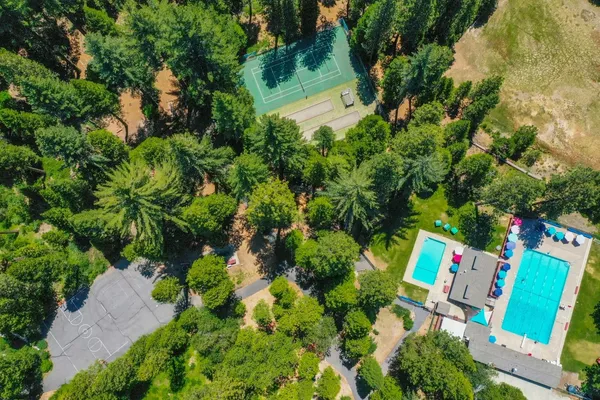 an aerial view of residential house with outdoor space and swimming pool