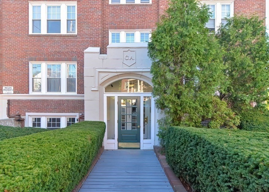 21 Bradlee Road, Unit 52 Medford, MA 02155 - Photo 1 of 22 a front view of a house with yard and green space